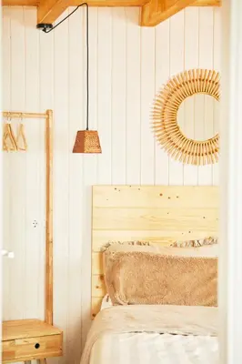 a bedroom with a bed and a mirror on the wall at Casa Montse. Apartamentos turísticos in Ribadeo