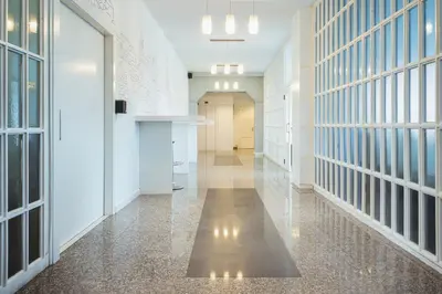 a hallway of an office building with a hallway of cells at Hotel Voar in Ribadeo