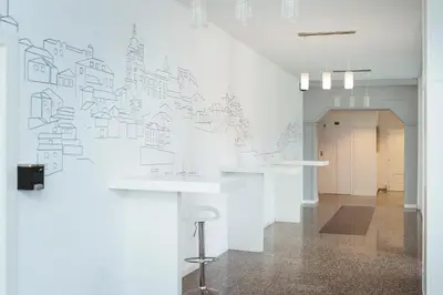 a hallway with a white wall with a drawing on it at Hotel Voar in Ribadeo