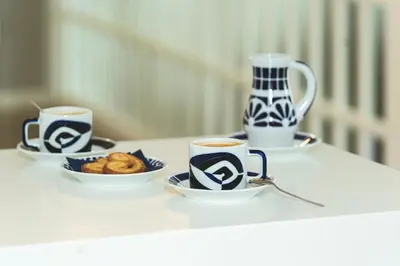 two cups of coffee and a plate of food on a table at Hotel Voar in Ribadeo