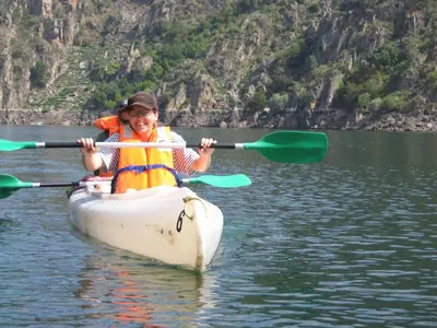 a young boy in a kayak on a lake at A Casa da Eira in Cerreda