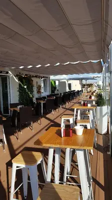a restaurant with tables and chairs and a large canopy at Hotel Mendez Nuñez in Lugo