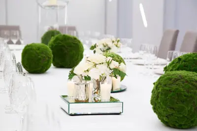 a white table with green bushes and vases with flowers at Hotel Mendez Nuñez in Lugo