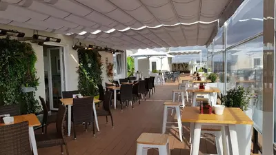a restaurant with tables and chairs on a patio at Hotel Mendez Nuñez in Lugo