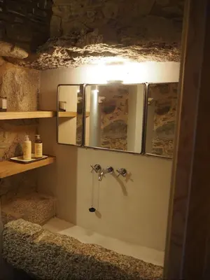 a bathroom with a shower with a mirror and a sink at Lar do Gado in Porta