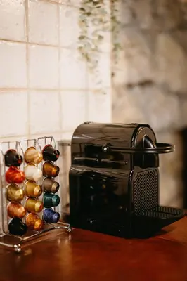 a toaster sitting on top of a table next to some bread at Apartamentos Rurales La Casina del Fontan in Valle de Lago