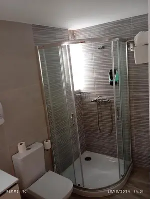 a bathroom with a shower and a toilet at dpCristal Sarria Centro in Sarria