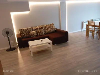 a living room with a couch and a table at dpCristal Sarria Centro in Sarria