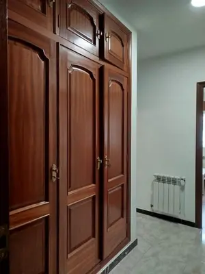 a pair of wooden cabinets in a room at dpCristal Sarria Centro in Sarria