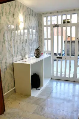 a room with a white desk and a door at dpCristal Sarria Centro in Sarria