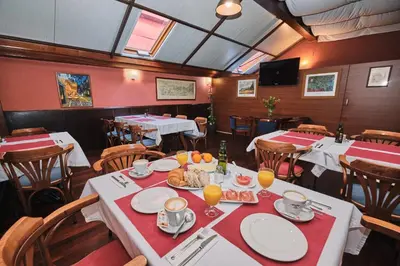 a restaurant with tables and chairs with food on them at Hotel Entrecercas in Santiago de Compostela