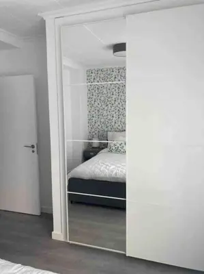 a bedroom with a bed and a mirror at Casa dos Alén in Ourense