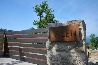a sign that says alen on a fence at Casa dos Alén in Ourense