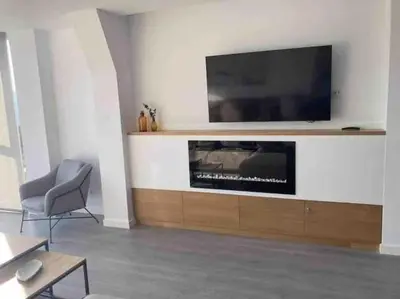 a living room with a flat screen tv on a wall at Casa dos Alén in Ourense