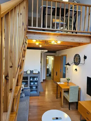 a room with a loft bed and a dining room at Apartamentos Ciudad Santiago in Santiago de Compostela