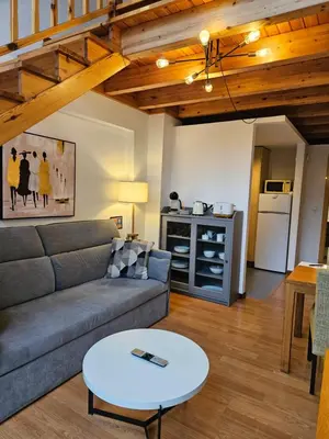 a living room with a couch and a table at Apartamentos Ciudad Santiago in Santiago de Compostela