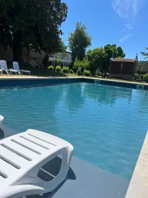 a white lounge chair sitting next to a swimming pool at Casa Grande de Cornide Santiago de Compostela in Teo