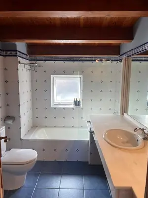 a bathroom with a tub and a toilet and a sink at Casa Grande de Cornide Santiago de Compostela in Teo
