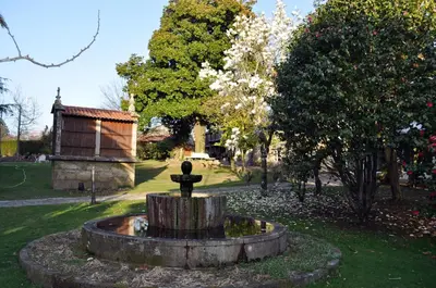 a fountain in the middle of a park at Casa Grande de Cornide Santiago de Compostela in Teo