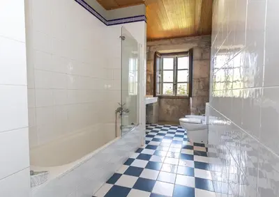 a bathroom with a tub and a toilet and a sink at Casa Grande de Cornide Santiago de Compostela in Teo