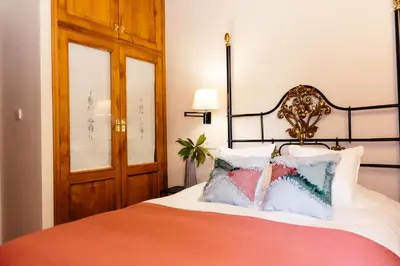 a bedroom with a bed with an orange and white at Casa Grande de Cornide Santiago de Compostela in Teo