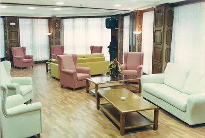 a living room with couches and chairs and a table at Hotel Princess in Ourense
