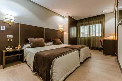 a bedroom with a large bed in a room at Hotel Princess in Ourense