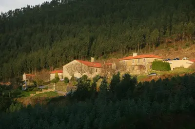 a group of buildings on a hill with trees at Casa Grande Do Bachao in Santiago de Compostela