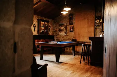 a room with a pool table in the middle of it at Casa Grande Do Bachao in Santiago de Compostela