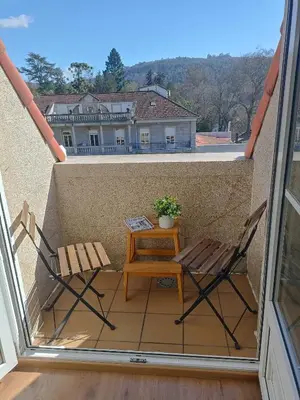 a small balcony with two chairs and a table at EL ATICO in Caldas de Reis
