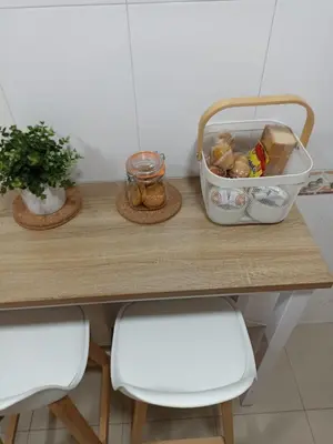 a table with two chairs and a container of food on it at EL ATICO in Caldas de Reis