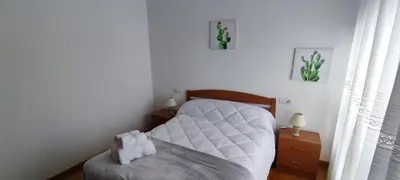 a bedroom with a white bed and a chair at MIRADOR DEL EO in Ribadeo