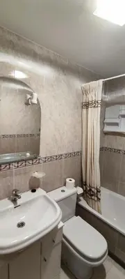 a bathroom with a white toilet and a sink at MIRADOR DEL EO in Ribadeo