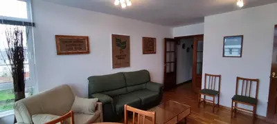 a living room with a green couch and chairs at MIRADOR DEL EO in Ribadeo