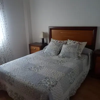 a bedroom with a bed with a white bedspread and pillows at Casa da Pilar - A Ponte in Portomourisco