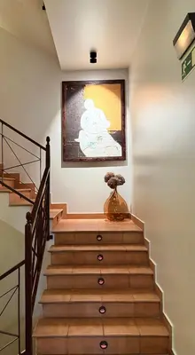 a staircase with a painting on the wall at Hotel Bouza in Ribadeo