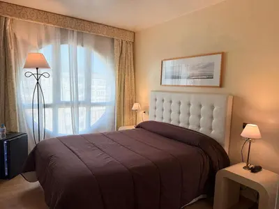 a hotel room with a bed and a window at Hotel Bouza in Ribadeo