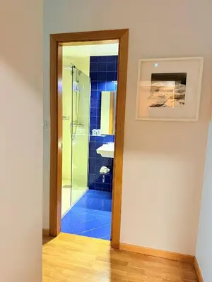 a bathroom with a shower with a glass door at Hotel Bouza in Ribadeo