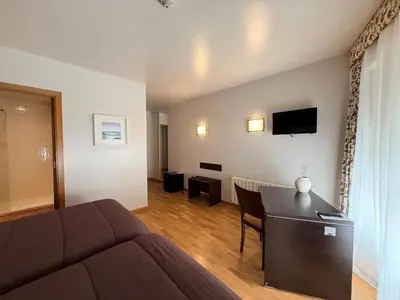 a living room with a couch and a table at Hotel Bouza in Ribadeo