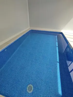 a large blue swimming pool with a blue tile floor at Astorga. León. Piscina. Casa Val de San Lorenzo. in Val de San Lorenzo