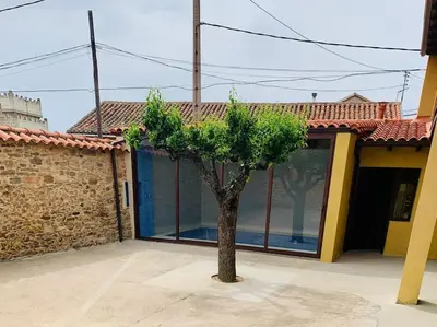 a small tree in front of a building at Astorga. León. Piscina. Casa Val de San Lorenzo. in Val de San Lorenzo