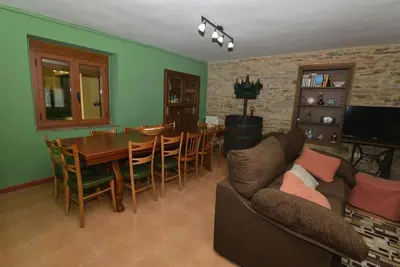 a living room with a couch and a table and chairs at Astorga. León. Piscina. Casa Val de San Lorenzo. in Val de San Lorenzo