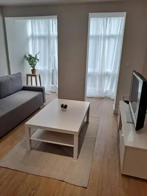 a living room with a couch and a coffee table at VISTAS MURALLA CENTRICO EN ZONA PEATONAL Wi-fi VUT LU 3270 in Lugo