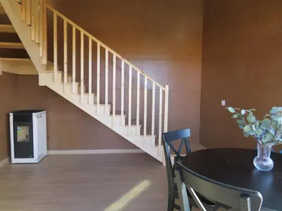 a dining room with a table and a staircase at Alda Cabanas Nature in Cabañas
