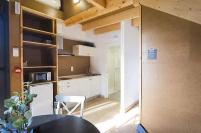 a small kitchen with a table and a chair at Alda Cabanas Nature in Cabañas