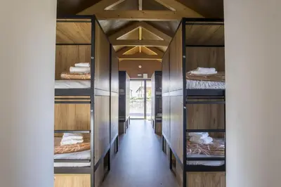 a hallway with multiple shelves of beds at Alda Cabanas Nature in Cabañas