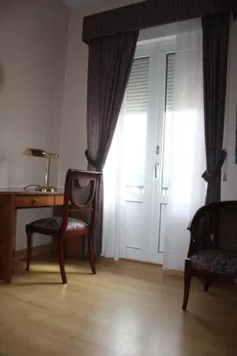 a room with a desk and a chair and a window at Hotel Las Sirenas in Viveiro