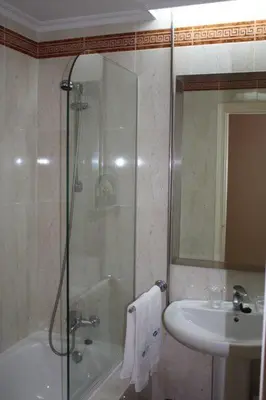 a bathroom with a shower and a sink at Hotel Las Sirenas in Viveiro