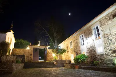 a church at night with the moon in the sky at Pazo Xan Xordo in Lavacolla