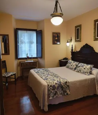 a bedroom with a bed and a window at Pazo Xan Xordo in Lavacolla